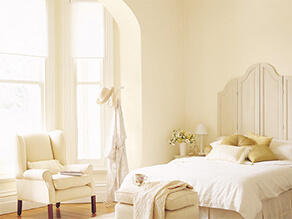 Light Yellow Cream Coloured Bedroom with Light Beige Furniture and Classic Wooden Floorboards